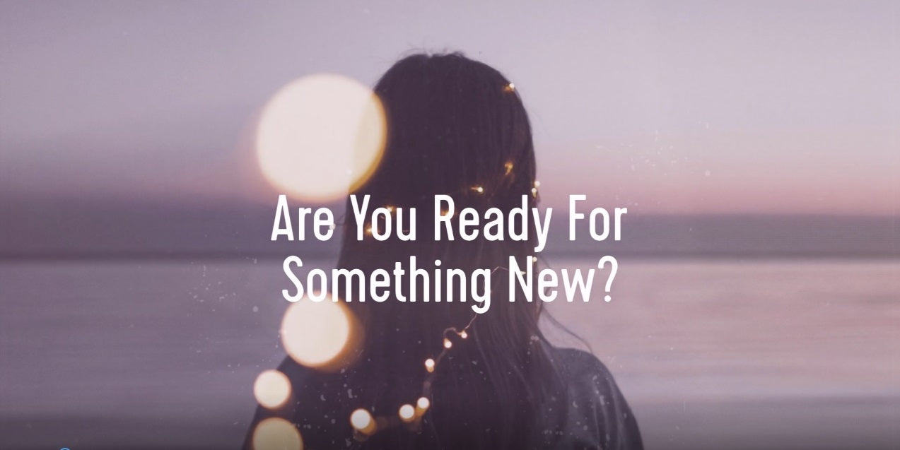 Women looking out to sea and "Are you ready for something new"
